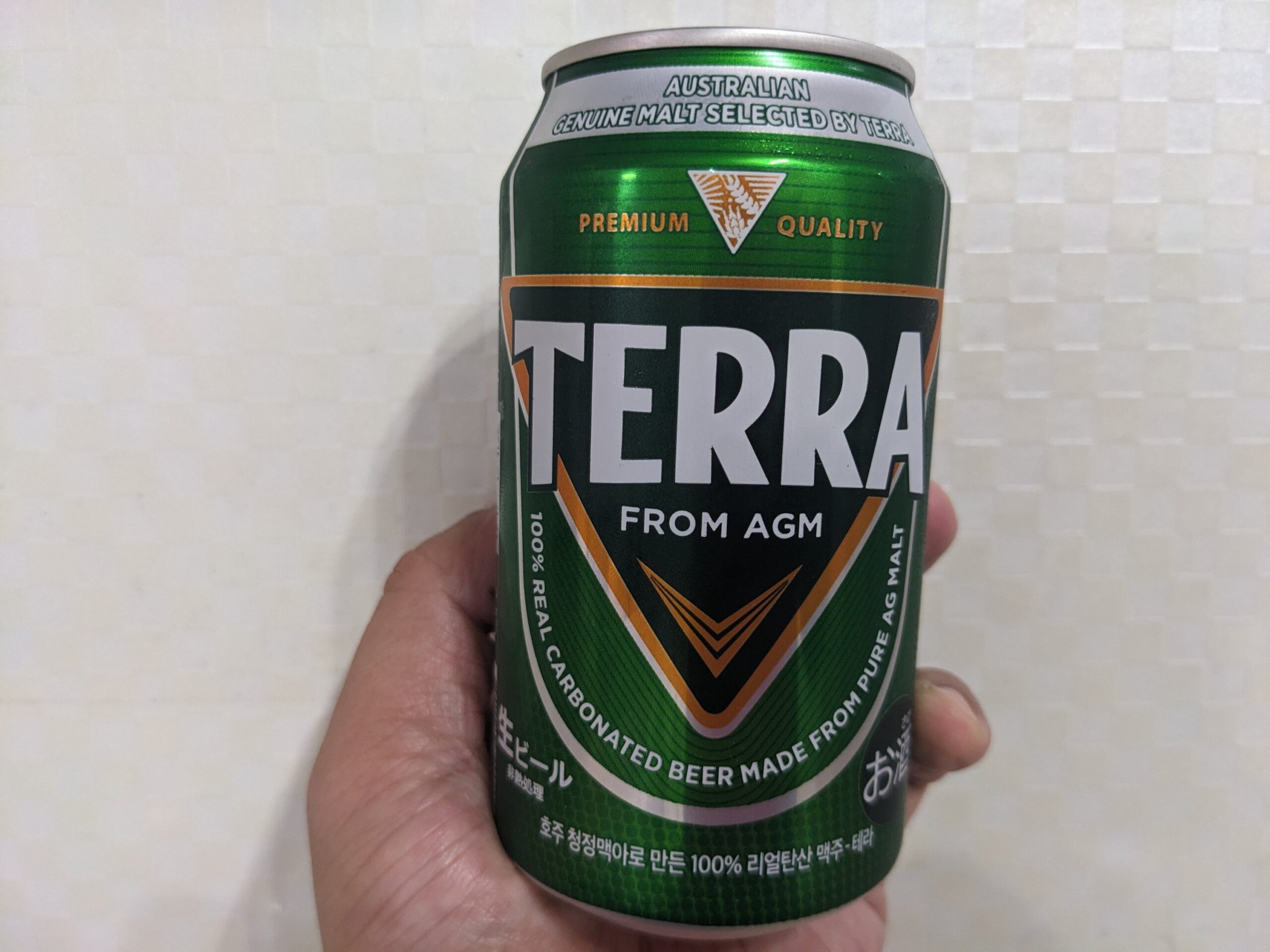 「TERRA（テラ）ビール」を手で持っているところ